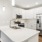 a kitchen with white cabinets