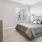 a bedroom with a bed and lamps