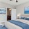 a bedroom with a bed and a fan