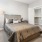 a bedroom with a bed and a lamp