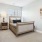 a bedroom with a bed and a lamp